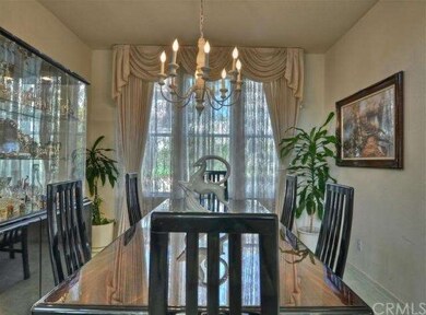 Elegant Dining Room with custom window coverings.