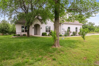Tudor home featuring stucco siding and a front yar
