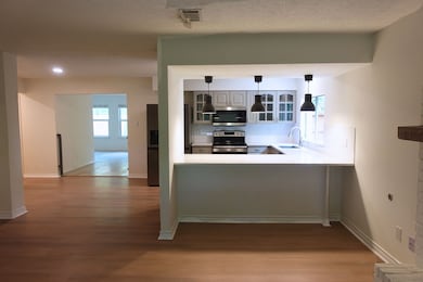 Kitchen with breakfast bar, pendant lights, and a