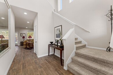 Staircase featuring wood finished floors and recessed lighting