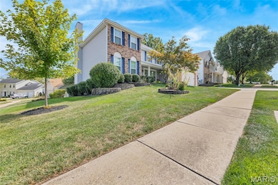 Summer exterior: Corner view of home featuring front yard, foliage and brick siding