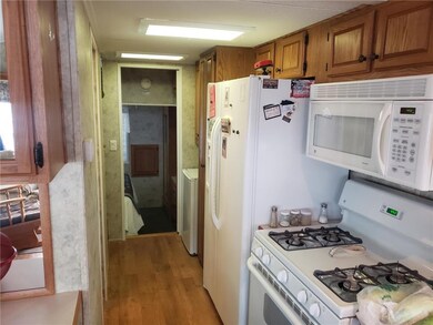 kitchen hallway leading to bathroom, stairs going 