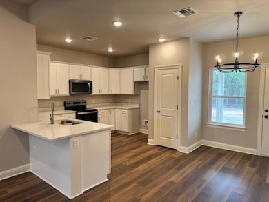 Kitchen featuring light countertops, stainless ste