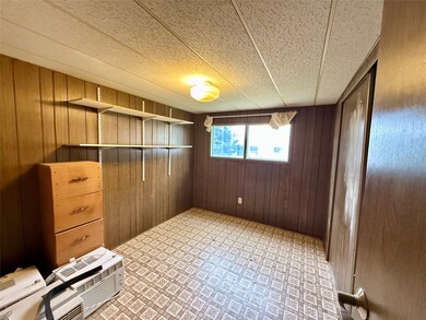 Spare room featuring wooden walls and an AC wall unit