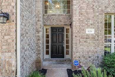 Property entrance featuring brick siding
