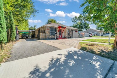 View of front of property with a carport and a front yard