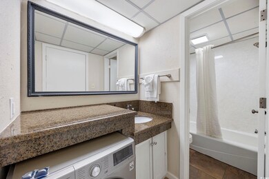 Bathroom with washer / dryer, vanity, shower / bat