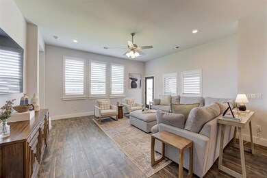 Living room with ceiling fan and wood-type floorin