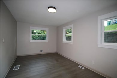 Empty room featuring wood finished floors and baseboards