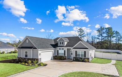 View of front facade with a garage and a front law