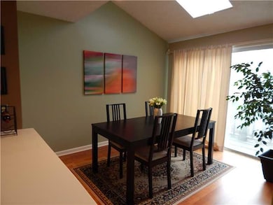 Dining Room. A skylight and glass doors flood the 