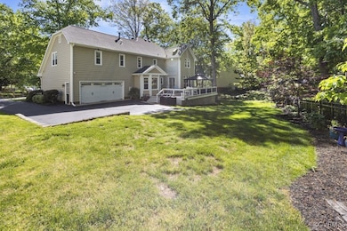 Back of property featuring an attached garage, a w