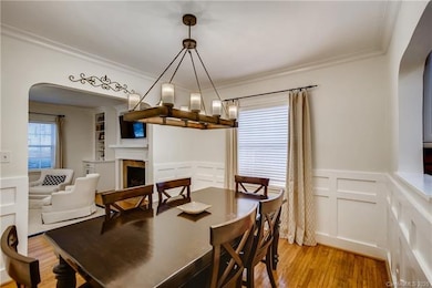 Dining Room with beautiful wood detail and curved openings to LR and Kitchen showing the character of the home.
