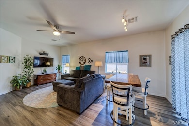 Living room with dark wood-style flooring, visible