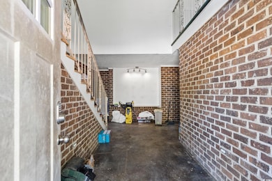 Unfurnished living room featuring concrete floorin