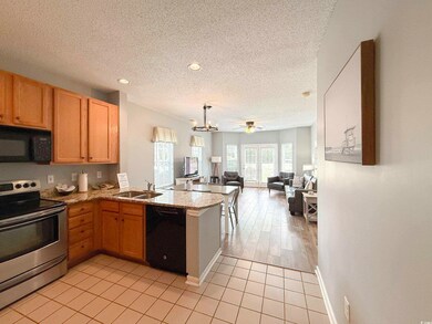 Kitchen with a sink, a peninsula, a textured ceili