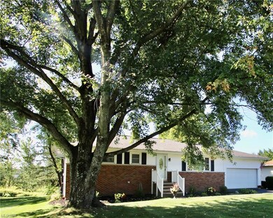 Ranch-style house with garage and a front yard