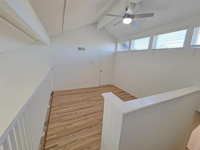 Hall with light hardwood / wood-style floors, a te