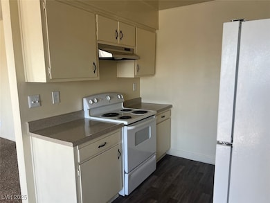 Kitchen featuring white appliances, under cabinet