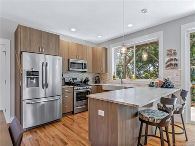 Stainless steel appliances, granite countertops, tile backsplash, gas stove and that HUGE kitchen window!