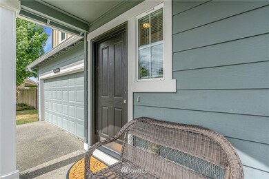 Quaint covered porch invites you tom come inside!