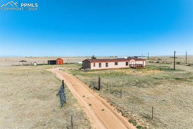 View of yard featuring a storage unit and a rural 