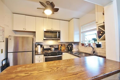 Kitchen has a ceiling fan with light