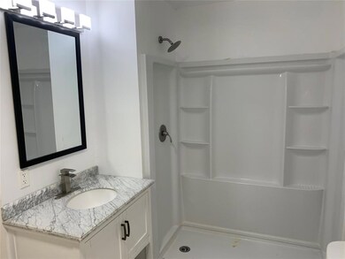 Bathroom featuring a shower and oversized vanity