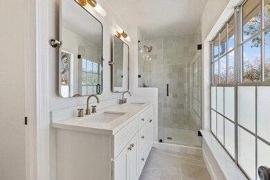 Primary bathroom features a modern design with a d