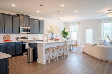 Kitchen with a sink, light countertops, light wood