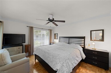 Bedroom with ceiling fan, light parquet flooring, 
