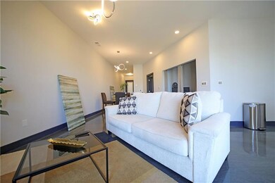 Living area with baseboards and recessed lighting