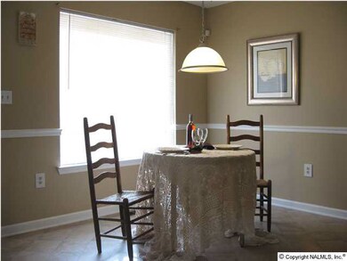Eat-in kitchen bathed in sunlight with a great view of the deck and backyard.
