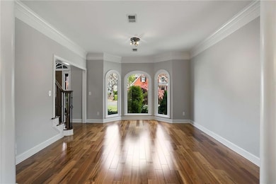 Unfurnished room with crown molding, visible vents