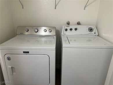Laundry room featuring laundry area, a textured wa