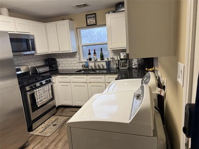 Kitchen featuring visible vents, a sink, decorati