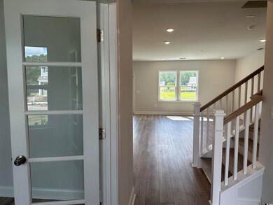 Corridor featuring wood-type flooring