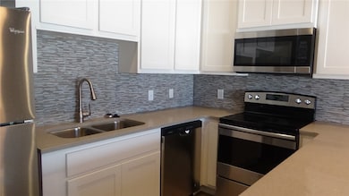 Kitchen featuring appliances with stainless steel