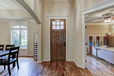 Inviting foyer boats a wood-trimmed door, hardwood