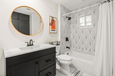 Bathroom with tile patterned flooring, vanity, sh