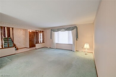 Spare room featuring light colored carpet and ornamental molding