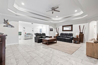 Living room with ornamental molding, ceiling fan, 