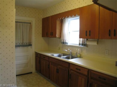 Kitchen with hardwood cabinets and tile backsplash