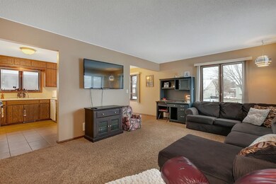 This room has neutral paint colors and two picture
