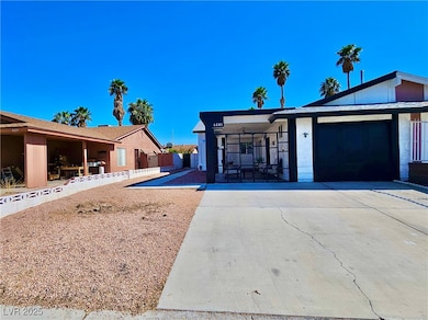 View of front of property featuring a garage, driv