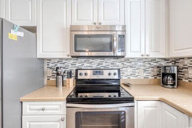 Kitchen with white cabinetry, stainless steel appl