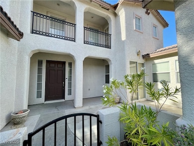 Entrance to property with stucco siding, a balcony