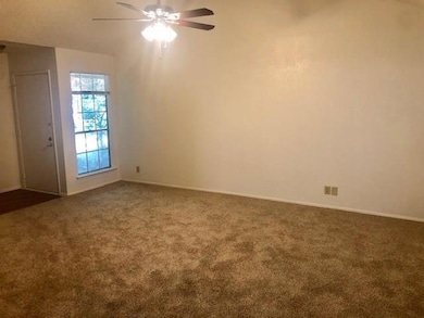 Unfurnished room with carpet, ceiling fan, and ba