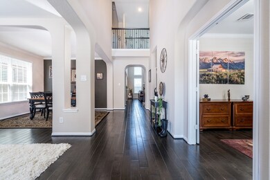 Dramatic two story entry with flowing wood floorin
