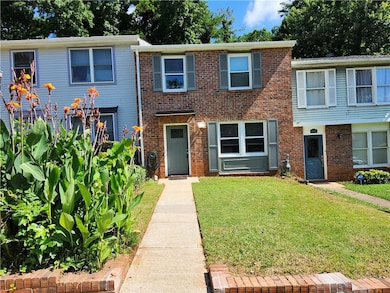 View of front of property featuring a front yard and brick siding